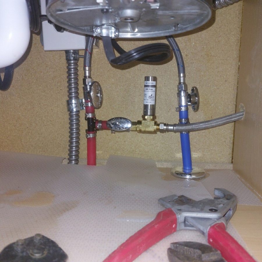 New water supply lines and shut-off valves installed under a kitchen sink by Affordable Rooter